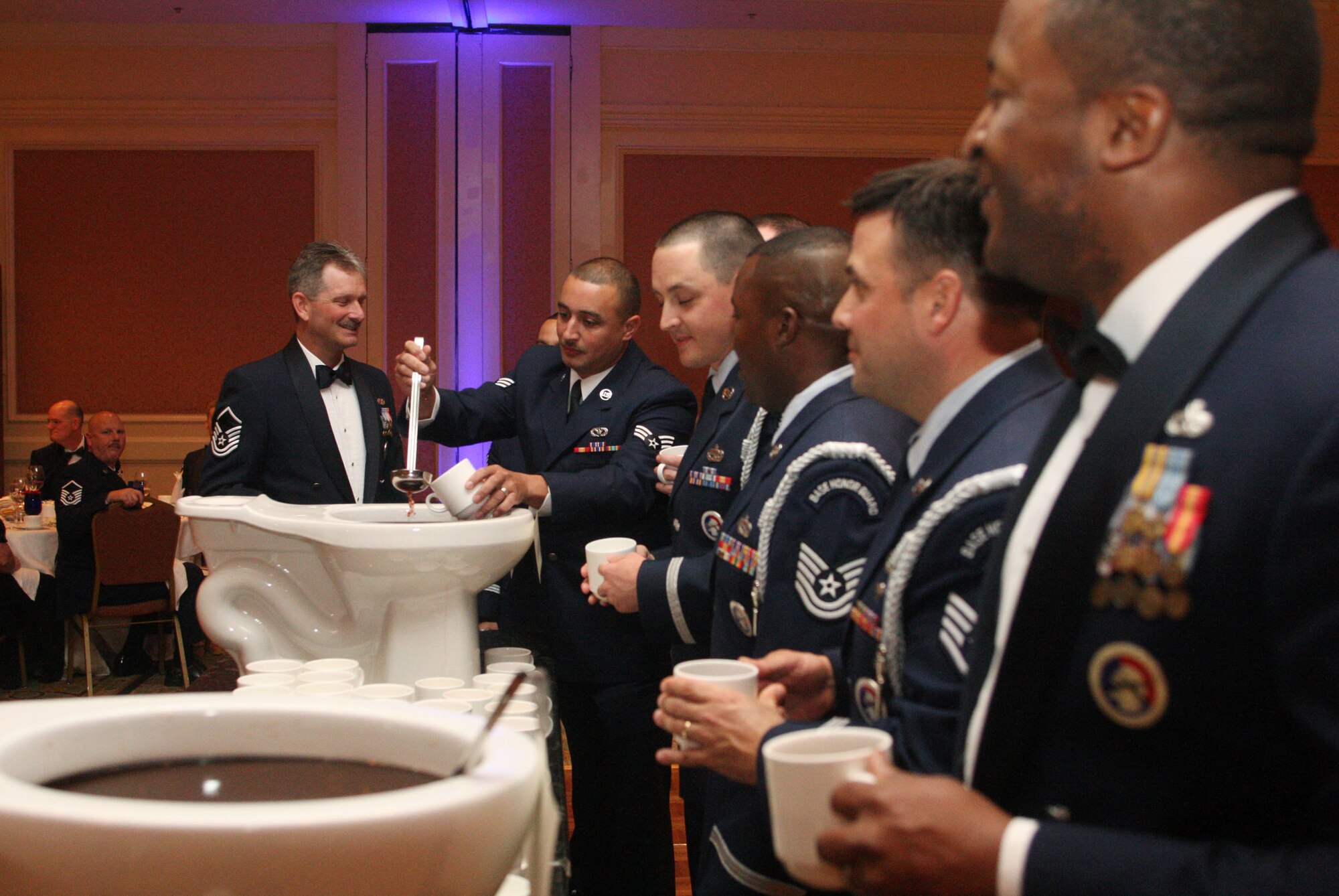 Members of the 94th Airlift Wing Honor Guard take their turn at the grog during the 94th Airlift Wing Dining Out held in downtown Atlanta, Ga., Oct. 1. (U.S. Air Force photo/Don Peek)