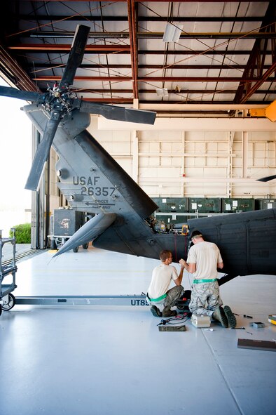 U.S. Air Force Staff Sgt. Michael Lindemann, right, and Senior Airman Keith Cassell, 41st Helicopter Maintenance Unit electronic warfare systems craftsman and journeyman, work on repairs to an HH-60G Pave Hawk wire harness Oct. 5, 2011, at Moody Air Force Base, Ga. Within the 41st HMU here, the Airmen work solely on HH-60s, but are capable of conducting work on any type of helicopter, cargo or bomber aircraft within the Air Force. (U.S. Air Force photo by Staff Sgt. Jamal D. Sutter/Released