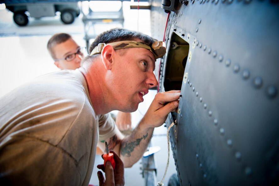 U.S. Air Force Staff Sgt. Michael Lindemann, 41st Helicopter Maintenance Unit electronic warfare systems craftsman, repairs a wire harness to an HH-60G Pave Hawk Oct. 5, 2011, at Moody Air Force Base, Ga. The wiring is connected to a missile warning system which notifies air crews of incoming missiles. (U.S. Air Force photo by Staff Sgt. Jamal D. Sutter/Released)