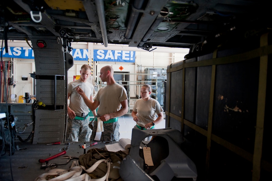From left to right, U.S. Air Force Airman 1st Class Jeffery Cox, electrical and environmental systems apprentice, Airman 1st Class Joshua Jaynes, crew chief apprentice, and Senior Airman Sindy Keefe, engine troop, discuss maintenance while working on an HH-60G Pave Hawk Oct. 5, 2011, at Moody Air Force Base, Ga. All three Airmen are part of the 41st Helicopter Maintenance Unit. Although they are from different career fields, they often come together to conduct maintenance to ensure the aircraft is prepared for flight. (U.S. Air Force photo by Staff Sgt. Jamal D. Sutter/Released)