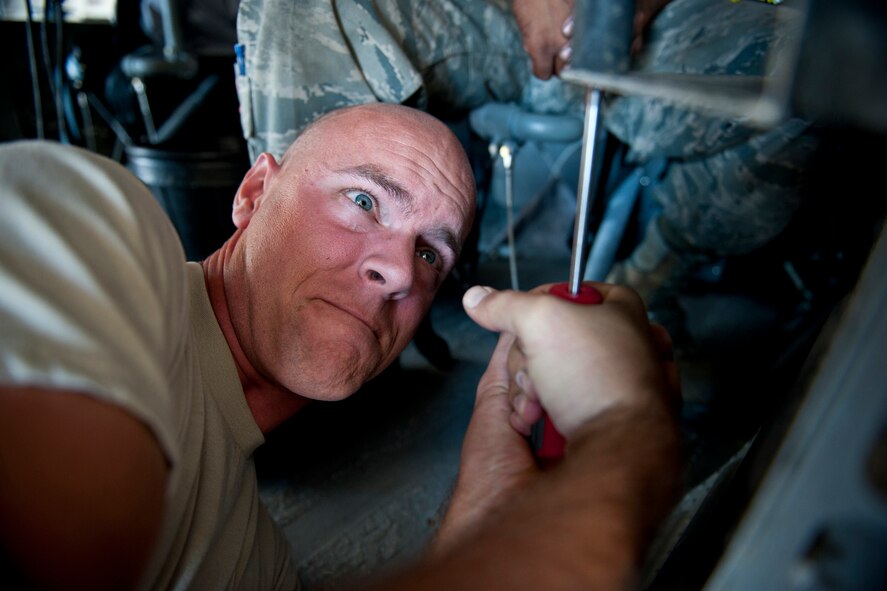 U.S. Air Force Airman 1st Class Joshua Jaynes, 41st Helicopter Maintenance Unit crew chief apprentice, loosens a screw to an HH-60G Pave Hawk grip handle Oct. 5, 2011, at Moody Air Force Base, Ga. Jaynes is from Columbia, Mo., and has been stationed at Moody for two months. He said no matter how difficult or tiring a job is, the most satisfying part of being a crew chief is watching helicopters launch and knowing he played a part in successfully getting it off the ground. (U.S. Air Force photo by Staff Sgt. Jamal D. Sutter/Released)