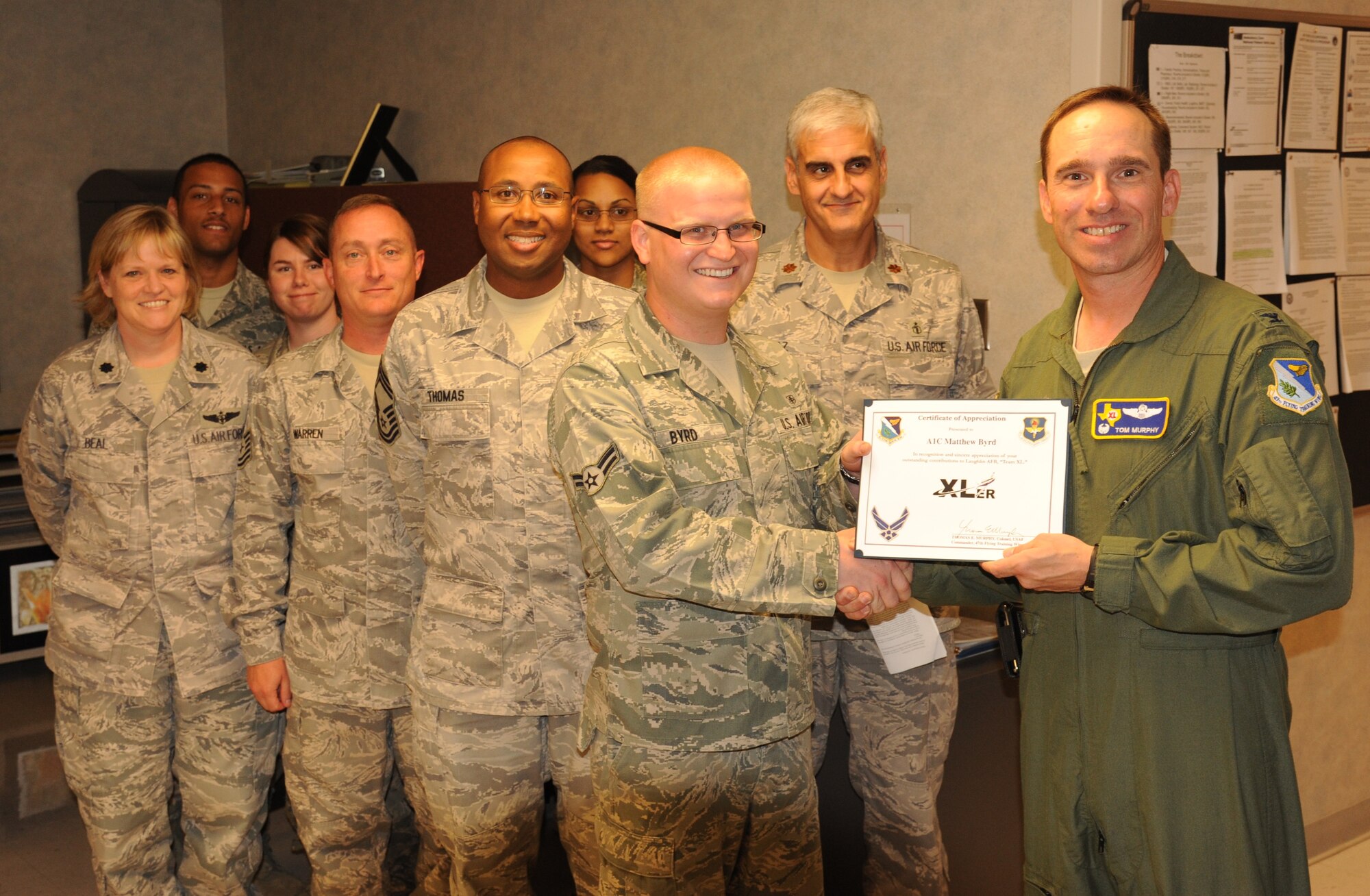 LAUGHLIN AIR FORCE BASE, Texas – Airman 1st Class Matthew Byrd, 47th Medical Operations Squadron, poses with Col. Tom Murphy, 47th Flying Training Wing commander, after being presented the XLer of the Week award here Sept. 28. The XLer is a weekly award chosen by wing leadership and given to those who consistently make outstanding contributions to Laughlin and their unit. (U.S. Air Force photo/Senior Airman Blake Mize)