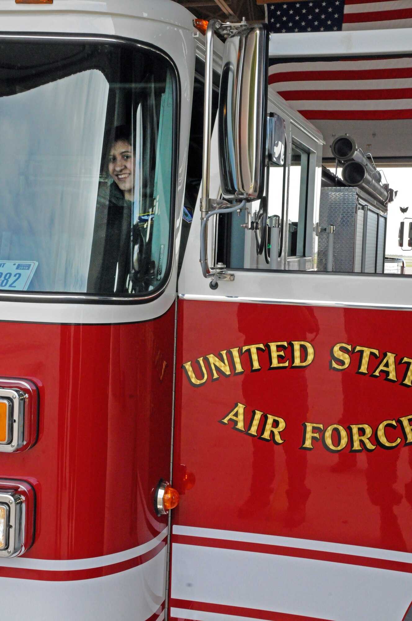LAUGHLIN AIR FORCE BASE, Texas -- Maria Ramon, an honorary pilot for a day, rides around in a fire truck here Sept. 28. Maria is mentally challenged and was selected to receive an all access tour of Laughlin and had the opportunity to a pilot for a day. (U.S. Air Force photo/Senior Airman Scott Saldukas)