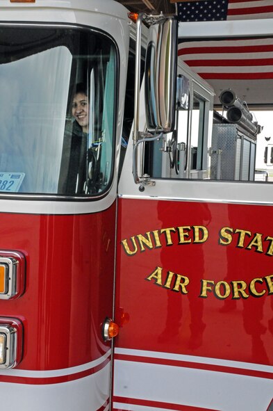 LAUGHLIN AIR FORCE BASE, Texas -- Maria Ramon, an honorary pilot for a day, rides around in a fire truck here Sept. 28. Maria is mentally challenged and was selected to receive an all access tour of Laughlin and had the opportunity to a pilot for a day. (U.S. Air Force photo/Senior Airman Scott Saldukas)