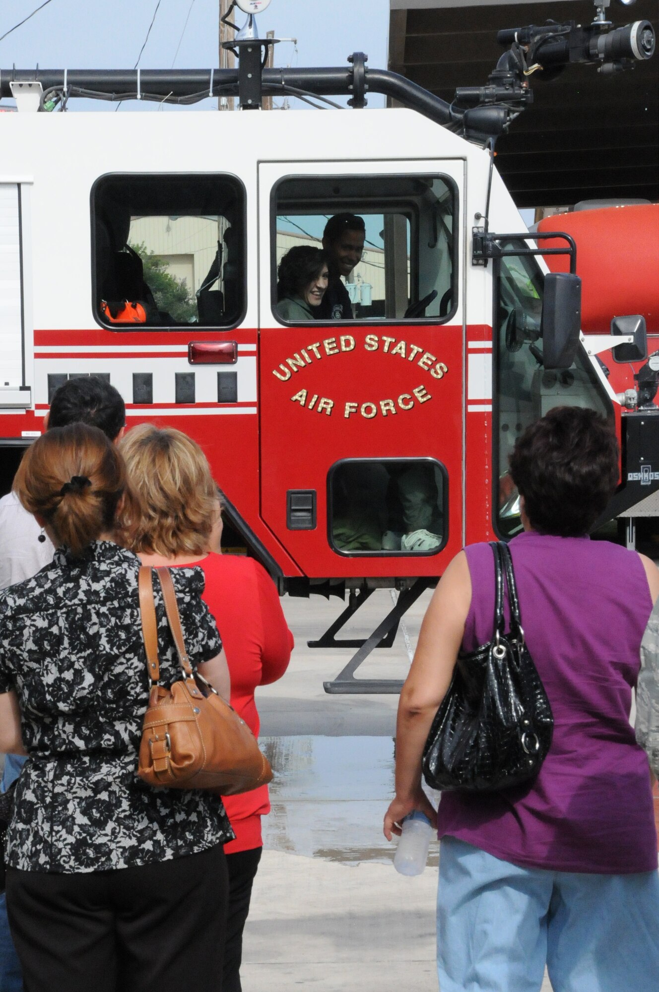 LAUGHLIN AIR FORCE BASE, Texas -- Maria Ramon, an honorary pilot for a day, rides around in a fire truck here Sept. 28. Maria is mentally challenged and was selected to receive an all access tour of Laughlin and had the opportunity to a pilot for a day. (U.S. Air Force photo/Senior Airman Scott Saldukas)