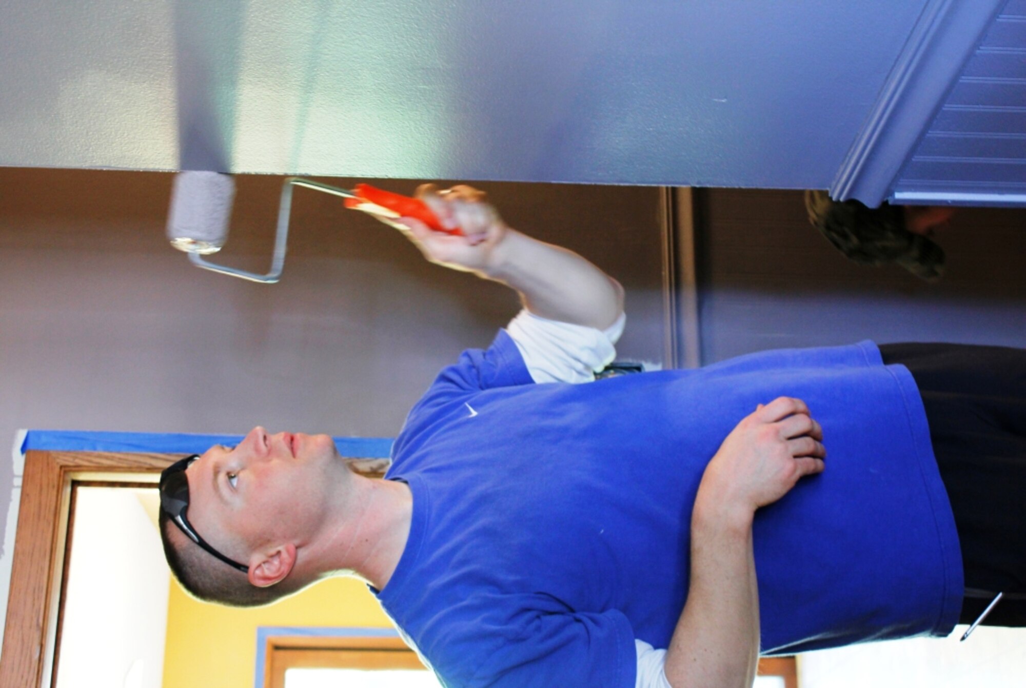 Tech Sgt. Ron Blackledge, 934th Security Forces Squadron, applies a new coat of paint to facilities used by the Eagan Lakeville Resource Center Oct. 4. (Air Force photo/Master Sgt. Nicolette Shegstad)