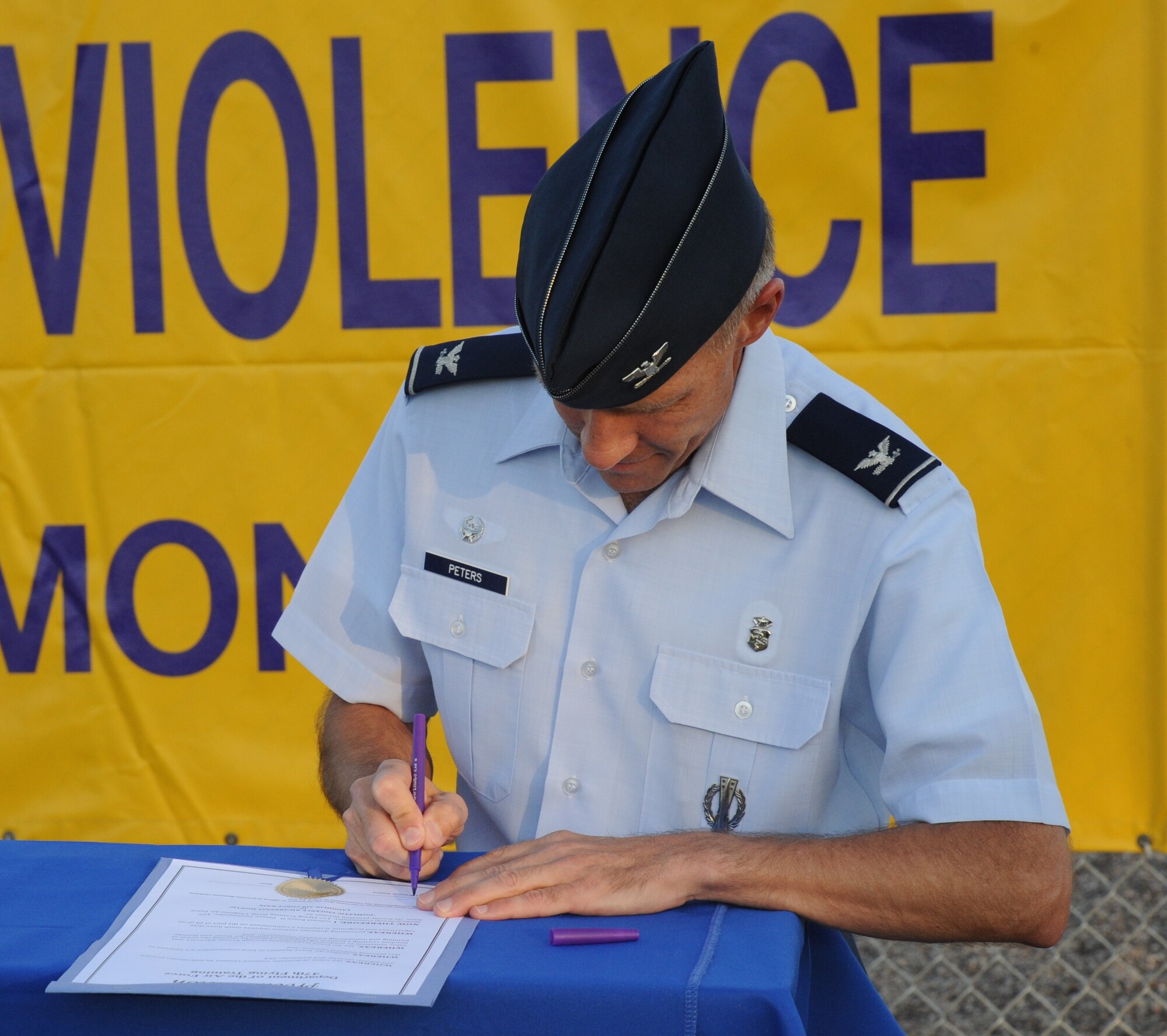 LAUGHLIN AIR FORCE BASE, Texas – Col. Pete Peters, 47th Medical Group commander, signs a proclamation declaring October as Domestic Violence Awareness Month at Laughlin’s medical clinic Oct.3. The designation is meant to bring to light the crime of domestic violence and its violation of an individual’s privacy and dignity, security and humanity. (U.S. Air Force photo/Senior Airman Blake Mize)