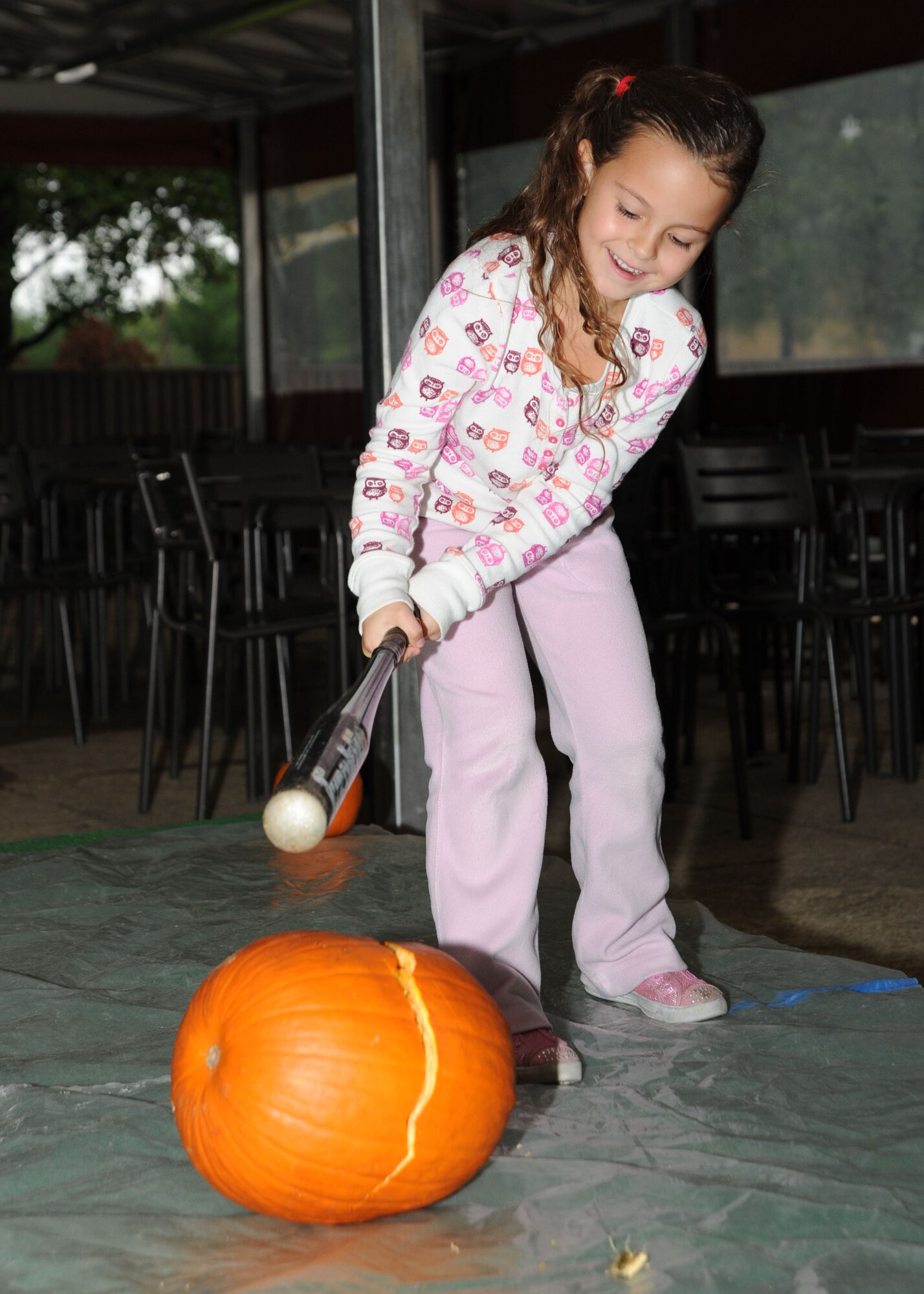 Ella Shipp, 5, daughter of Army Staff Sgt. David Shipp, Baltimore Recruiting Battalion recruiter, cracks open a pumpkin during the Pumpkin Bash at the Community Activity Center on Oct. 1. The Pumpkin Bash was a Family Advocacy hosted event which kicked off domestic violence awareness month. (U.S. Air Force photo/ Airman 1st Class Bahja J. Jones) 

