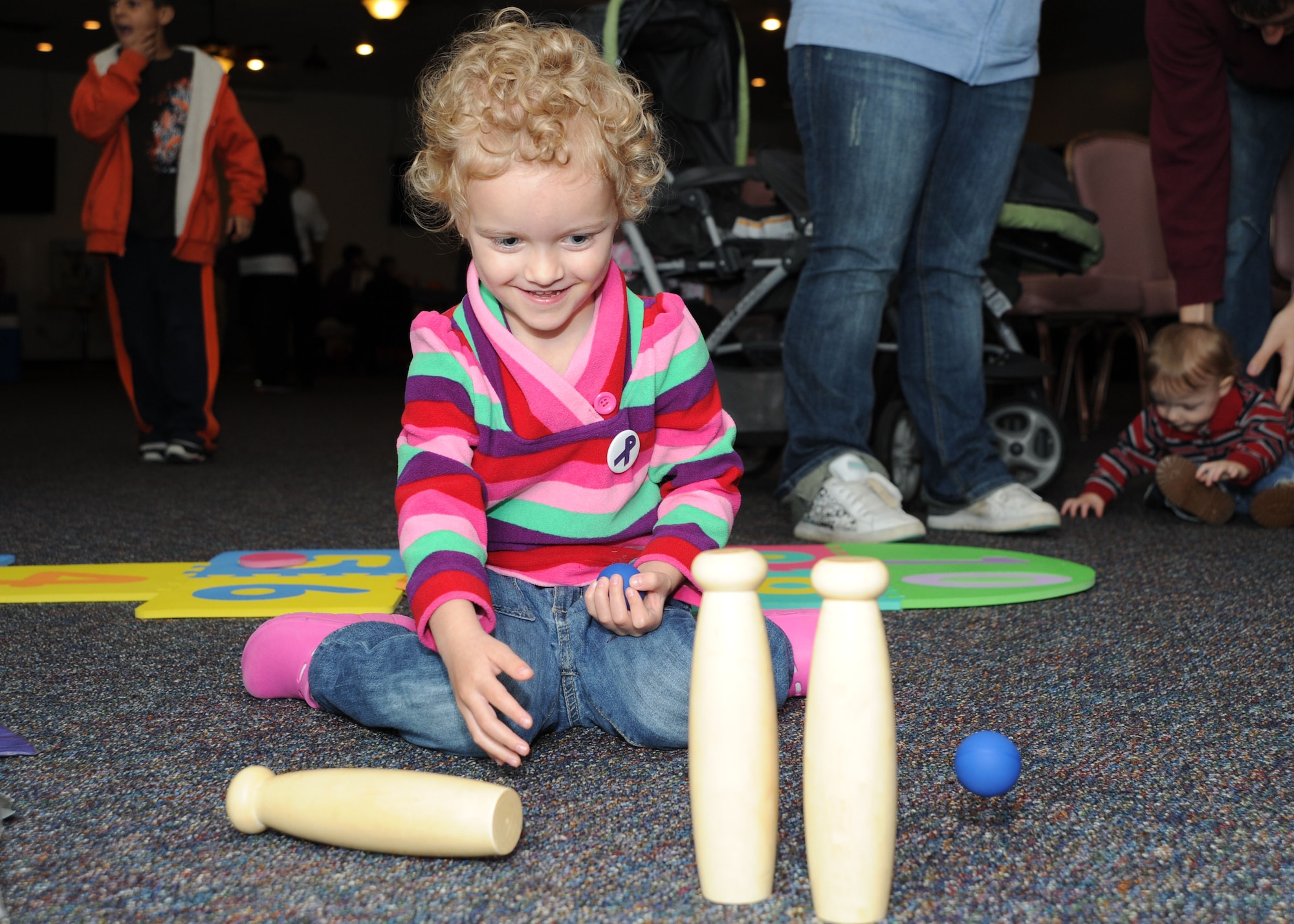 Annalise Olsen, 4, Daughter od Keri and Staff Sgt. Derek Olsen, 779th Medical Group education and training manager, plays a miniature bowling game at the Pumpkin Bash in the Community Activty Center on Oct. 1. The Pumpkin Bash was a Family Advocacy hosted event which kicked-off Domestic Violence Awareness Month. (U.S. Air Force photo/ Airman 1st Class Bahja J. Jones) 


