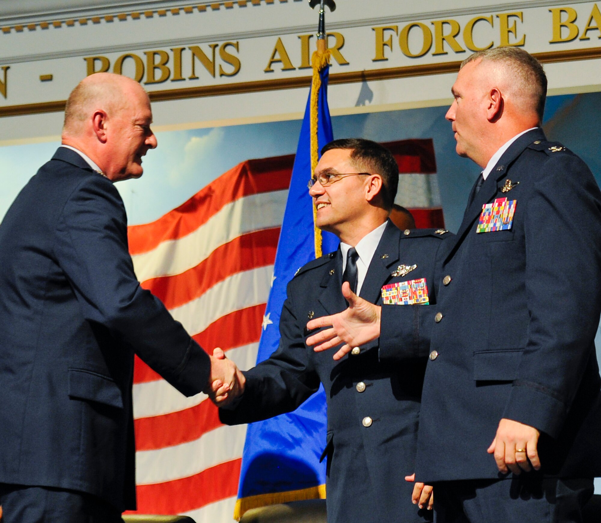 U.S. Air Force Col. William Welsh, left, 116th Air Control Wing commander, shakes hands with U.S. Air Force Col. L. Dean Worley Jr., incoming 461st Air Control Wing commander, and U.S. Air Force Col. Jeffrey Herd, outgoing 116th Air Control Wing commander, during the 116th ACW Change of Command and 461st ACW Activation ceremonies at the Museum of Aviation, Robins Air Force Base, Ga., Sept. 30, 2011.  During the ceremonies, Herd relinquished command of the 116th ACW to Air National Guard Commander, Col. William Welsh, and the 461st ACW was activated, commanded by Col. Worley.  (National Guard photo by Master Sgt. Roger Parsons/Released)