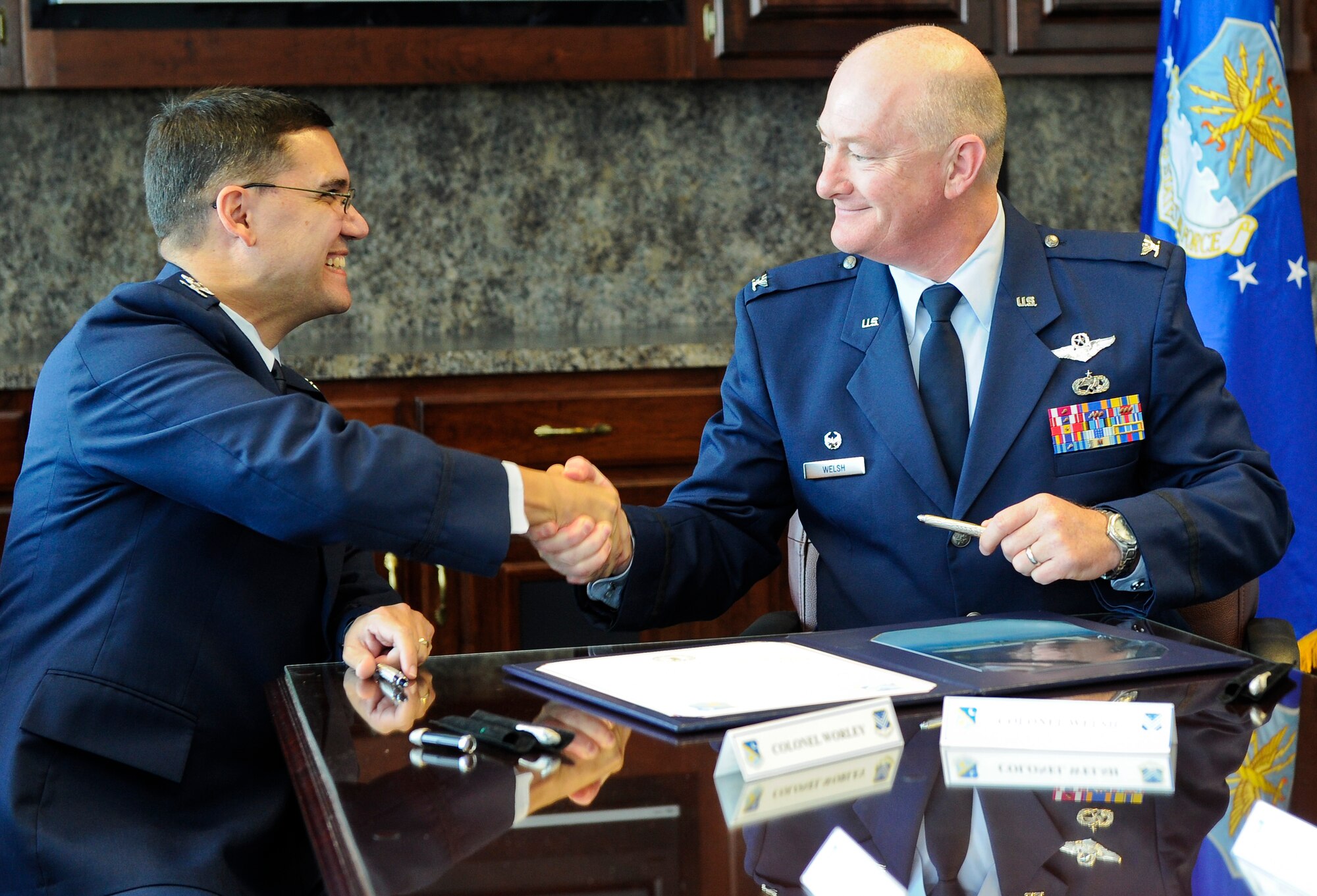 U.S. Air Force Col. L. Dean Worley Jr., left, 461st Air Control Wing commander, and Col. William Welsh, 116th Air Control Wing commander, shake hands after signing a memorandum of understanding prior to the 116th ACW Change of Command and the 461st ACW activation ceremonies at the Museum of Aviation, Robins Air Force Base, Ga., Sept. 30, 2011.  The memorandum of understanding established the initiative to optimize day-to-day operations of both wings working together as an active associate unit.  (National Guard photo by Master Sgt. Roger Parsons/Released)