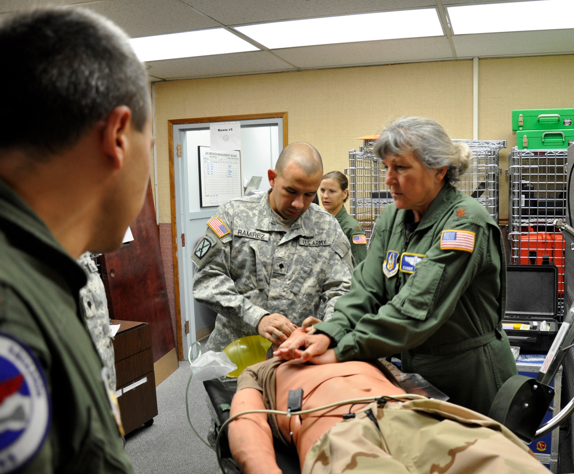 MCCHORD FIELD, Wash.- U.S. Air Force Maj. Connie Kohler, (right) 446th Aeromedical Evacuation Squadron flight nurse, performs chest compressions on a wounded "patient" while U.S. Army Specialist Ramirez (center) keeps oxygen flowing with a bag-valve mask during a medical training exercise, Oct. 4, 2011 here. This training, in particular, was advanced cardiac life support training, which is a training requirement for medical personnel. (U.S. Air Force photo by Jake Chappelle)