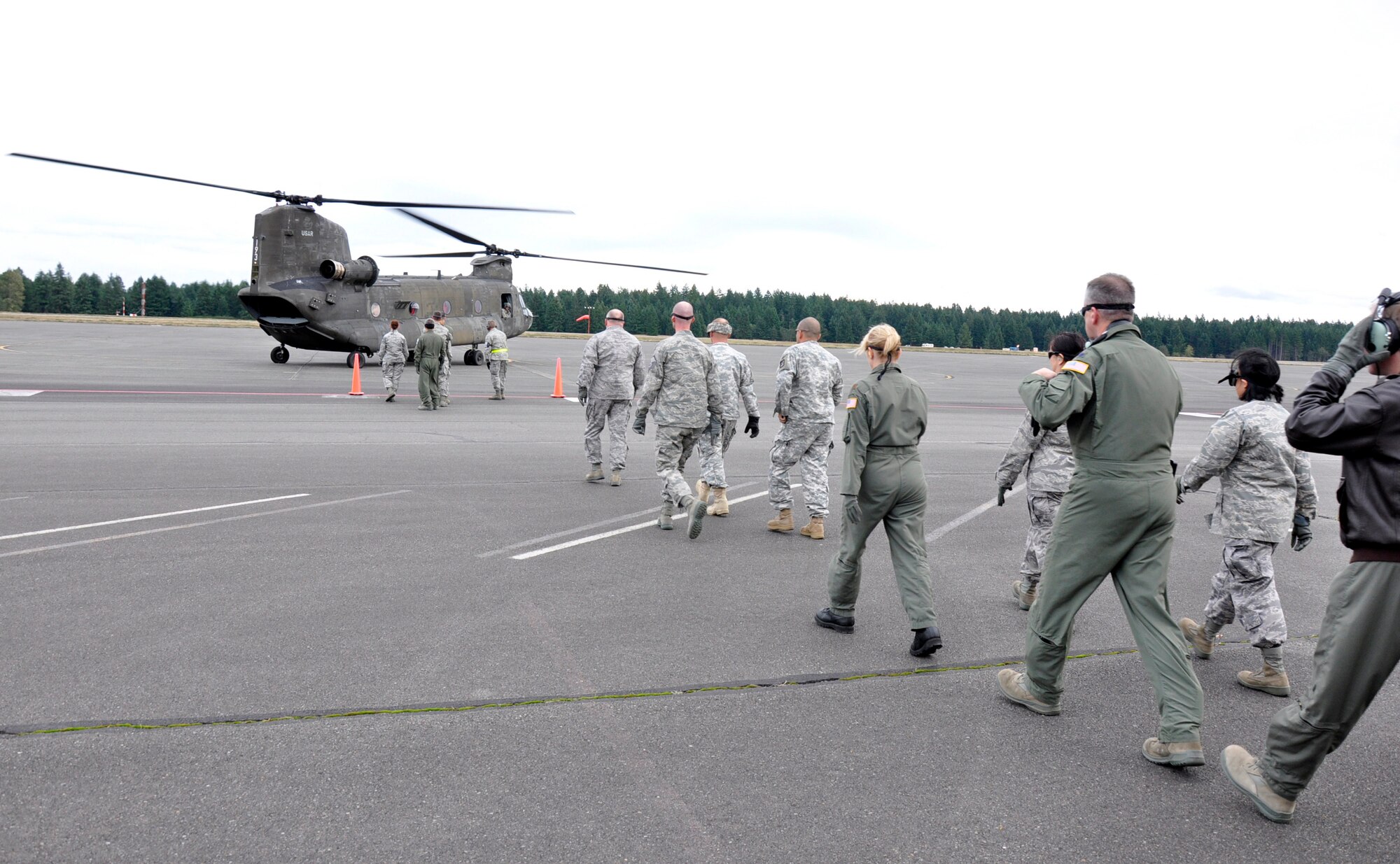 MCCHORD FIELD, Wash.- Reservists with the 446th Aeromedical Evacuation Squadron and 446th Aerospace Medicine Squadron here, approach an Army CH-47 Chinook helicopter, with six wounded "patients" from Joint Base Lewis-McChord- Main, in a medical training exercise, Oct. 4, 2011. Some of the training covered was advanced cardiac life support training, which is a training requirement for medical personnel. The medical crews unloaded the "patients" and took them to a mock treatment facility for medical care. (U.S. Air Force photo by Jake Chappelle)