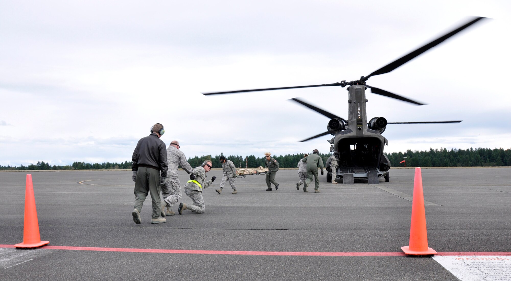 MCCHORD FIELD, Wash.- Reservists with the 446th Aeromedical Evacuation Squadron and 446th Aerospace Medicine Squadron out of McChord Field, Wash., approach an Army CH-47 Chinook helicopter, from Joint Base Lewis-McChord- Main, in order to unload and treat wounded patients during a medical training exercise, Oct. 4, 2011. Some of the training covered was advanced cardiac life support training, which is a training requirement for medical personnel. The medical crews took the "wounded" to a mock treatment facility for medical care. (U.S. Air Force photo by Jake Chappelle)