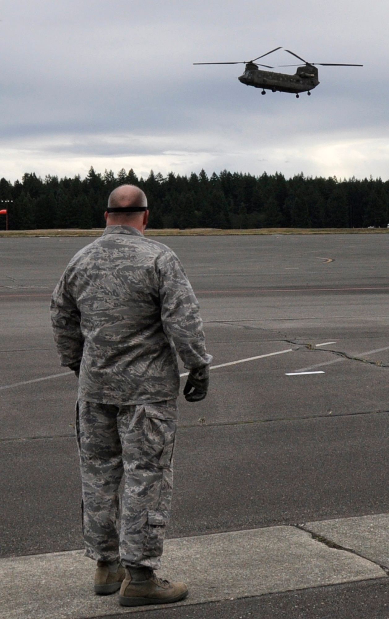 MCCHORD FIELD, Wash.- U.S. Air Force Lt. Col.  Kenneth Winslow, a flight nurse with the 446th Aeromedical Evacuation Squadron out of McChord Field, Wash., awaits on the flightline for an Army CH-47 Chinook helicopter, with six patients from Joint Base Lewis-McChord- Main as part of a medical training exercise, Oct. 4, 2011. Some of the training covered was advanced cardiac life support training, which is a requirement of all AE members. (U.S. Air Force photo by Jake Chappelle)