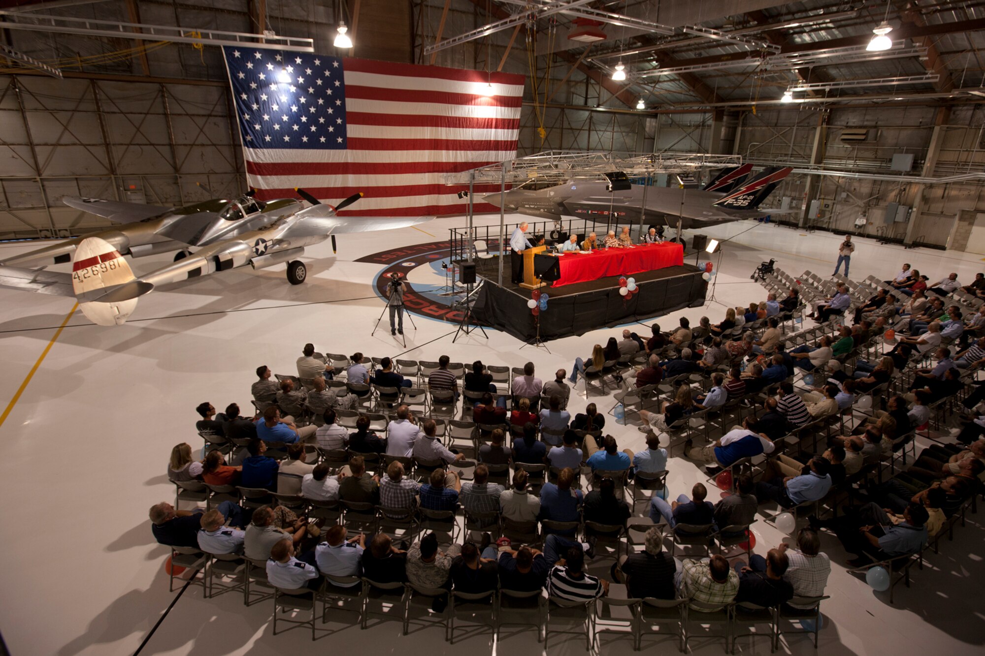 A panel of four World War II veterans and former P-38 Lightning pilots speak about their experiences flying the aircraft during World War II. The Oct. 3 panel discussion brought together pilots of the first Lightning with the next generation of those doing Developmental Test and Evaluation on the new F-35 Lightning II. (Photo by Paul Weatherman)