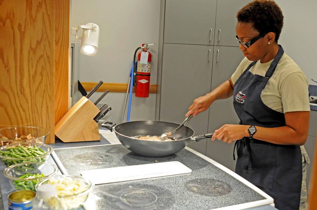 SCHRIEVER AIR FORCE BASE, Colo. -- Staff Sgt. Vanessa Arthur, Schriever Health and Wellness Center dietician, begins cooking the boneless skinless chicken breast for Chinese chicken, the meal featured during the HAWC healthy cooking demo here Sept. 28. Team Schriever members attended the demo to learn and try healthier recipes. (U.S. Air Force photo/Staff Sgt. Patrice Clarke)