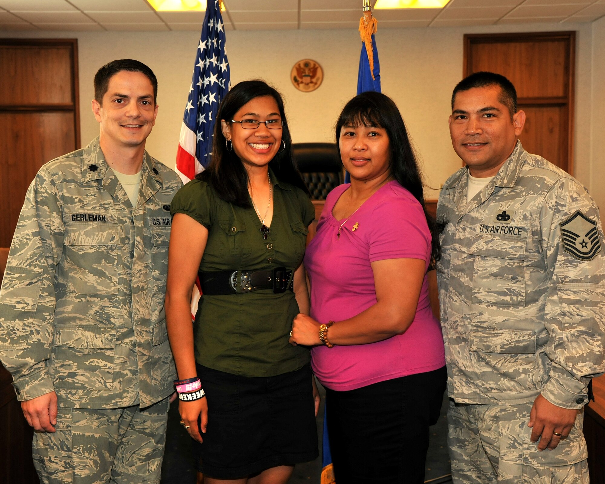 RAF Mildenhall, England – Lt. Col. Robert Gerleman, 100th Air Refueling Wing staff judge advocate, Christine San Agustin, Maria San Agustin and Master Sgt. James San Agustin, 100th Logistics Readiness Squadron, completed an enlistment ceremony here Oct. 4, 2011. Christine San Agustin took the Oath of Enlistment making her one of the Air Force’s newest enlisted Airmen, following in her father’s footsteps. (U.S. Air Force photo/Senior Airman Jerilyn Quintanilla) 