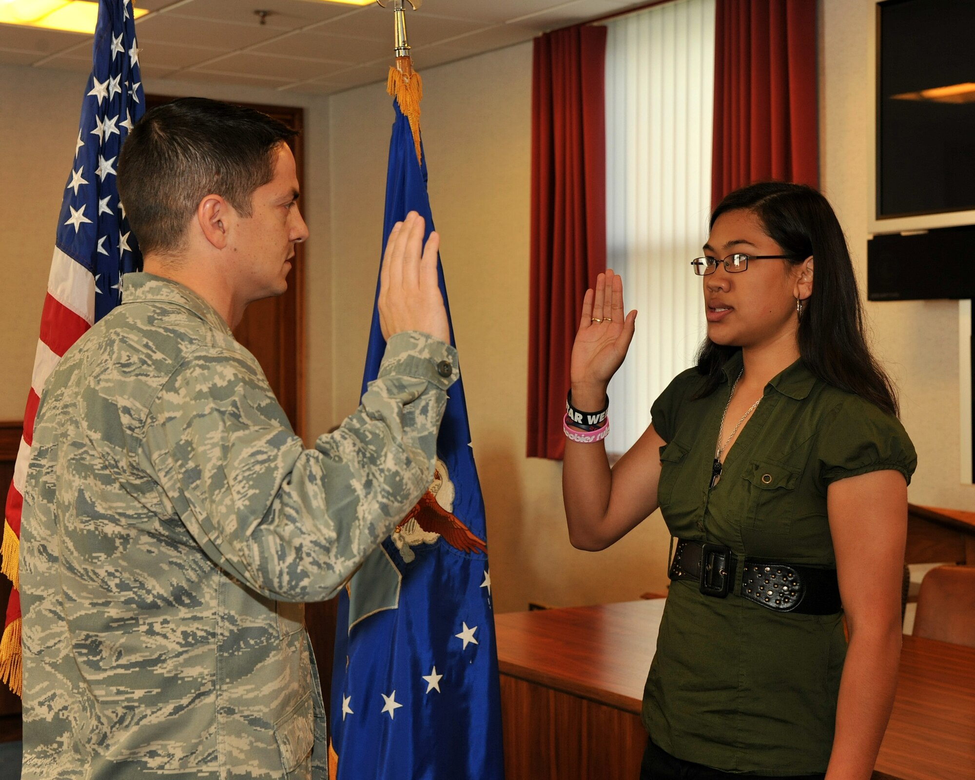 RAF Mildenhall, England – Lt. Col. Robert Gerleman, 100th Air Refueling Wing staff judge advocate, administers the Oath of Enlistment to Christine San Agustin, daughter of Master Sgt. James San Agustin, 100th Logistics Readiness Squadron, at the legal office here Oct. 4, 2011. The oath signifies her official entry into the U.S. Air Force. (U.S. Air Force photo/Senior Airman Jerilyn Quintanilla)