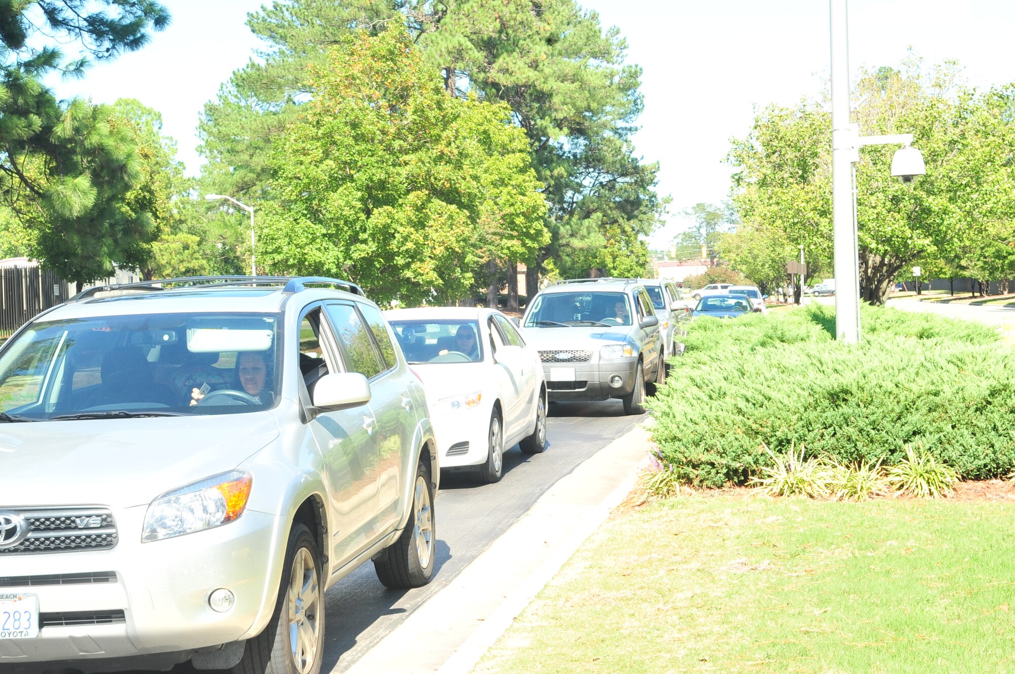 A line of vehicles await entry onto Seymour Johnson Air Force Base, N.C., Oct. 4, 2011. The base populace will see more Airmen securing the front gate as augmentees from various offices volunteer to secure entry control points, balancing manning issues with the heavily tasked 4th Security Forces Squadron. All augmentees are given hands-on training including tactical skills, weapon evaluations and must have recommendations from their chain of command. (U.S. Air Force photo by Senior Airman Marissa Tucker)