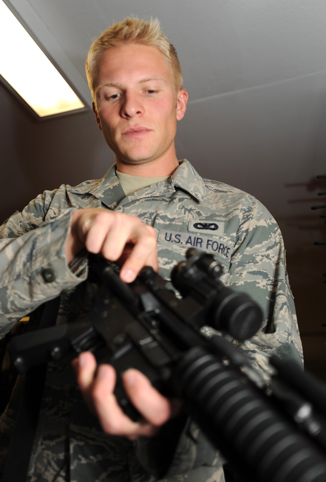 Senior Airman Erik Ippel, 22nd Security Forces Squadron resource protection manager, demonstrates safely clearing an M4 rifle at the SFS vault Oct. 5, 2011, McConnell Air Force Base, Kan. Ippel is responsible for inspecting all controlled areas on McConnell, and ensuring all necessary procedures are in place and followed. (U.S. Air Force photo by Airman 1st Class Laura L. Valentine)