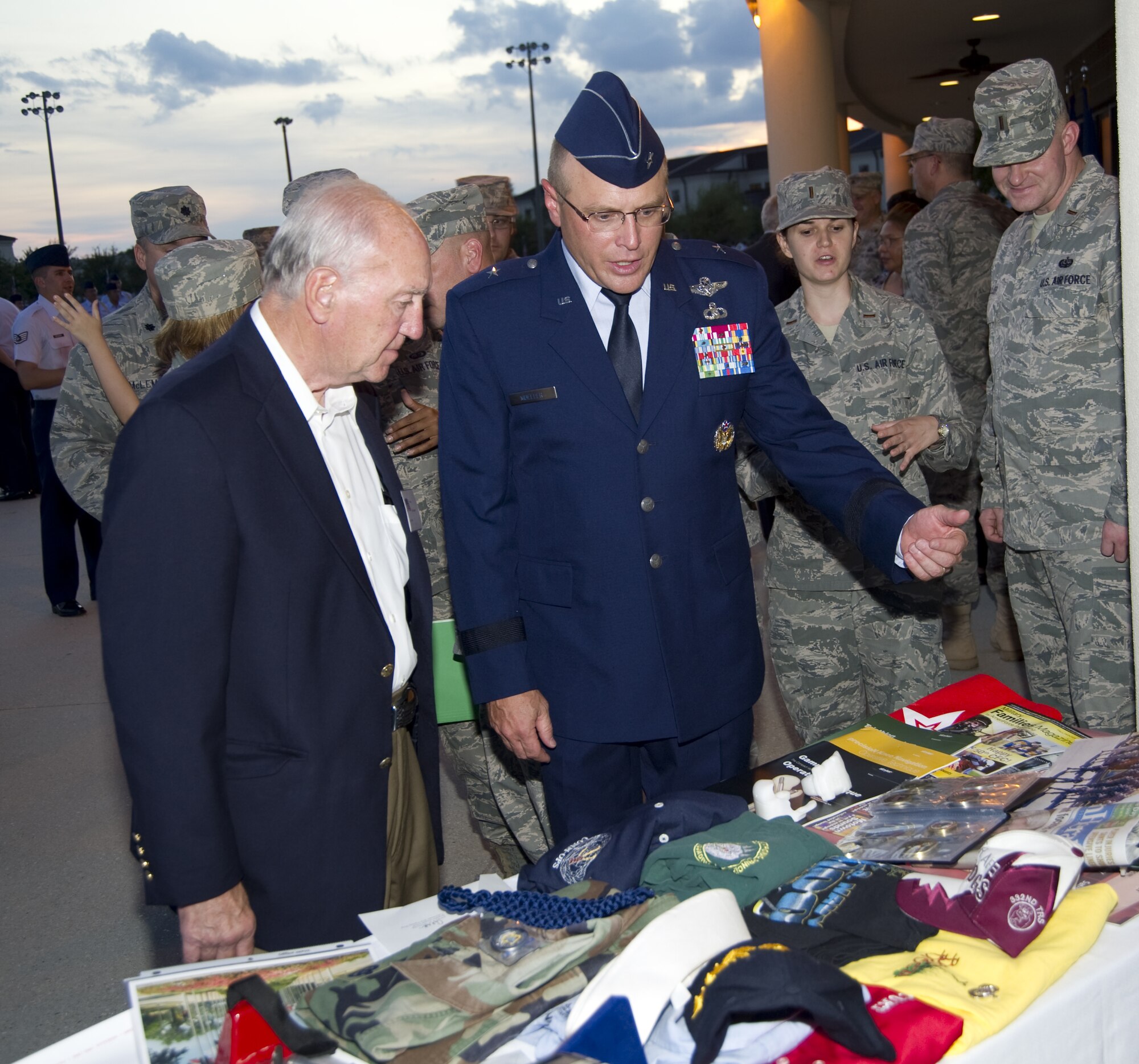 Brig. Gen. Andrew Mueller, 81st Training Wing commander, shows Biloxi Mayor A.J. Holloway some of the items to be included in a time capsule that was buried after the 81st Training Group student parade, Sept. 29.  Holloway represented other honorary commanders in reviewing the parade with Mueller. The time capsule, in  commemoration of Keesler’s 70th birthday earlier this year, was buried exactly 70 years after Keesler’s airplane and engine mechanics school began operations.  (U.S. Air Force photo by Adam Bond)