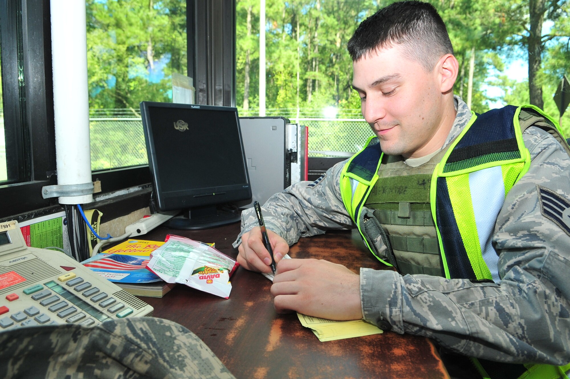 Senior Airman Benjamin Robarge prepares a visitor pass on Seymour Johnson Air Force Base, N.C., Oct. 4, 2011. Robarge is a 4th Security Forces augmentee, an Airman who is given specialized training on how to conduct patrols, manage entry control points and conduct physical security on-base. Robarge is a 4th Force Support Squadron food services technician and hails from Montpellier, Vt. (U.S. Air Force photo by Senior Airman Marissa Tucker) 