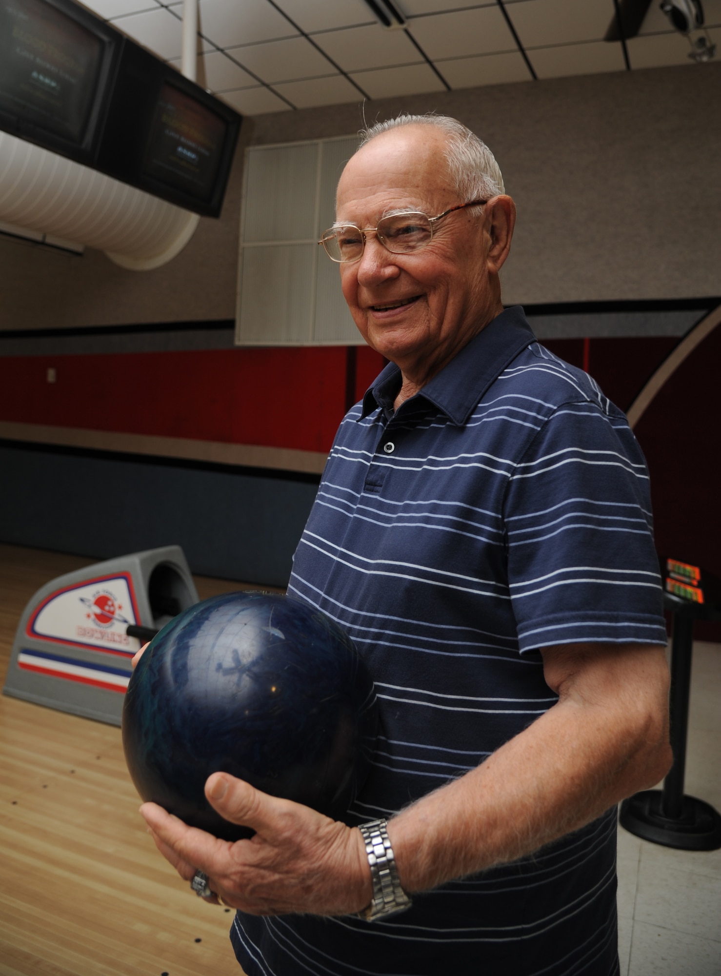 Bernard Moyer picks up his 12-pound ball just before scoring his second spare in a row during practice for his Tuesday night league.  (U.S. Air Force photos by Airman 1st Class Heather Heiney)