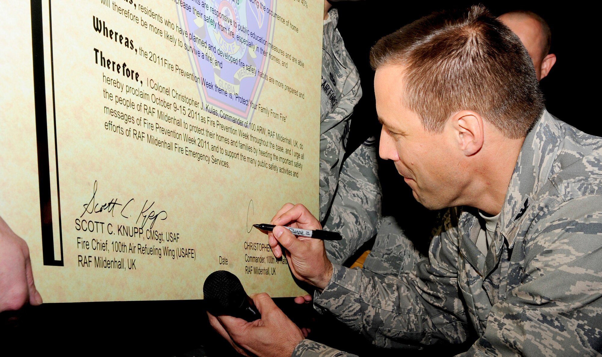 RAF MILDENHALL, England -- Col. Christopher Kulas, 100th Air Refueling Wing commander, signs the Fire Prevention Week Proclamation here Oct. 4, 2011. This year’s slogan is ‘Protect your family from fire!’ The slogan pertains to the importance of having a fire evacuation plan and fire safety awareness in each home to help ensure safety and prevent casualties. (U.S. Air Force photo/Senior Airman Ethan Morgan)