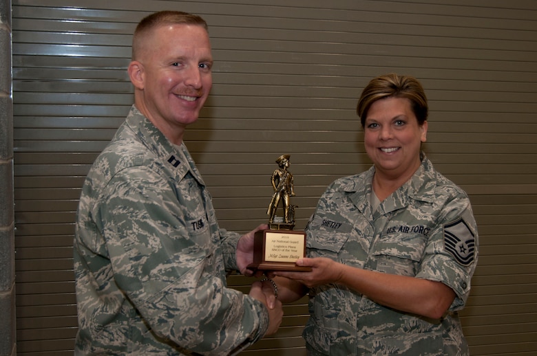 Master Sgt. Zoe Shetley receives her Air National Guard Logistics Plans Senior NCO of the Year trophy from Capt. Chris Tusing on Sunday, June 5, 2011. Shetley, with over 17 years of experience in logistics, was nominated for the award by Capt. Tusing. (National Guard photo by Staff Sgt. Michael Dickson)