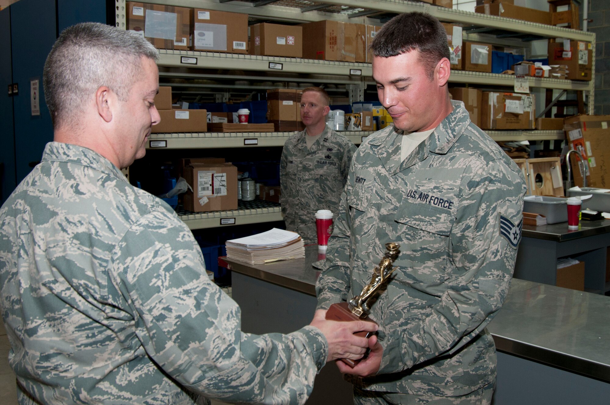 Staff Sgt. Michael Hewitt receives the Air National Guard Traffic Management NCO of the Year trophy from Maj. Charles Nassar Sunday, June 5, 2011. Hewitt was nominated for the award by Senior Master Sgt. Floyd Angelo. (National Guard photo by Staff Sgt. Michael Dickson)