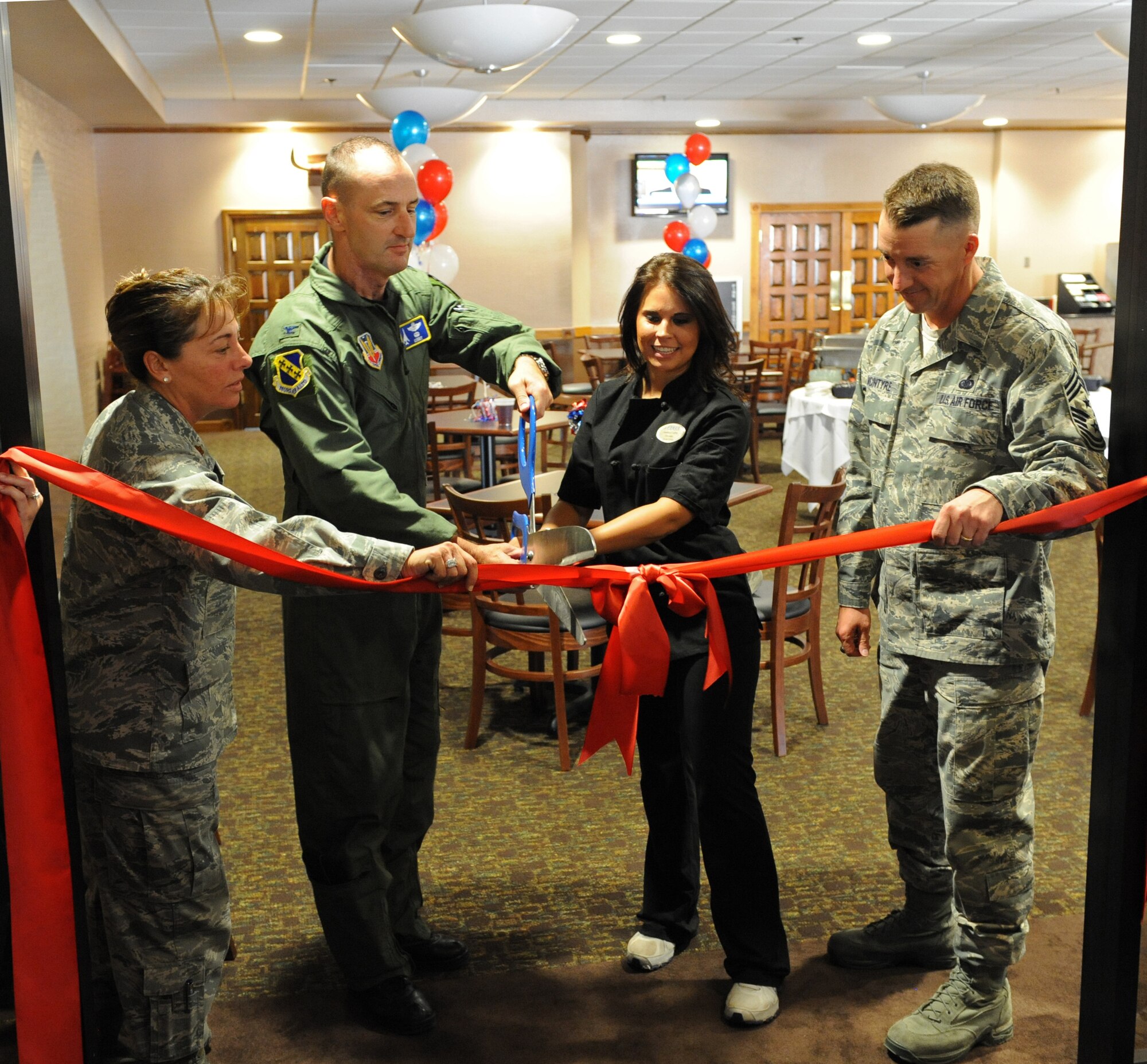 Col. David Been, 7th Bomb Wing commander, cuts a ribbon to officially re-open the Heritage Club dining room, Sept. 30, 2011, at Dyess Air Force Base, Texas. The Heritage Club was re-opened with several improvements to include the lighting and layout, as well as new furniture and a drink machine. (U.S. Air Force photo by Airman 1st Class Peter Thompson/Released)

