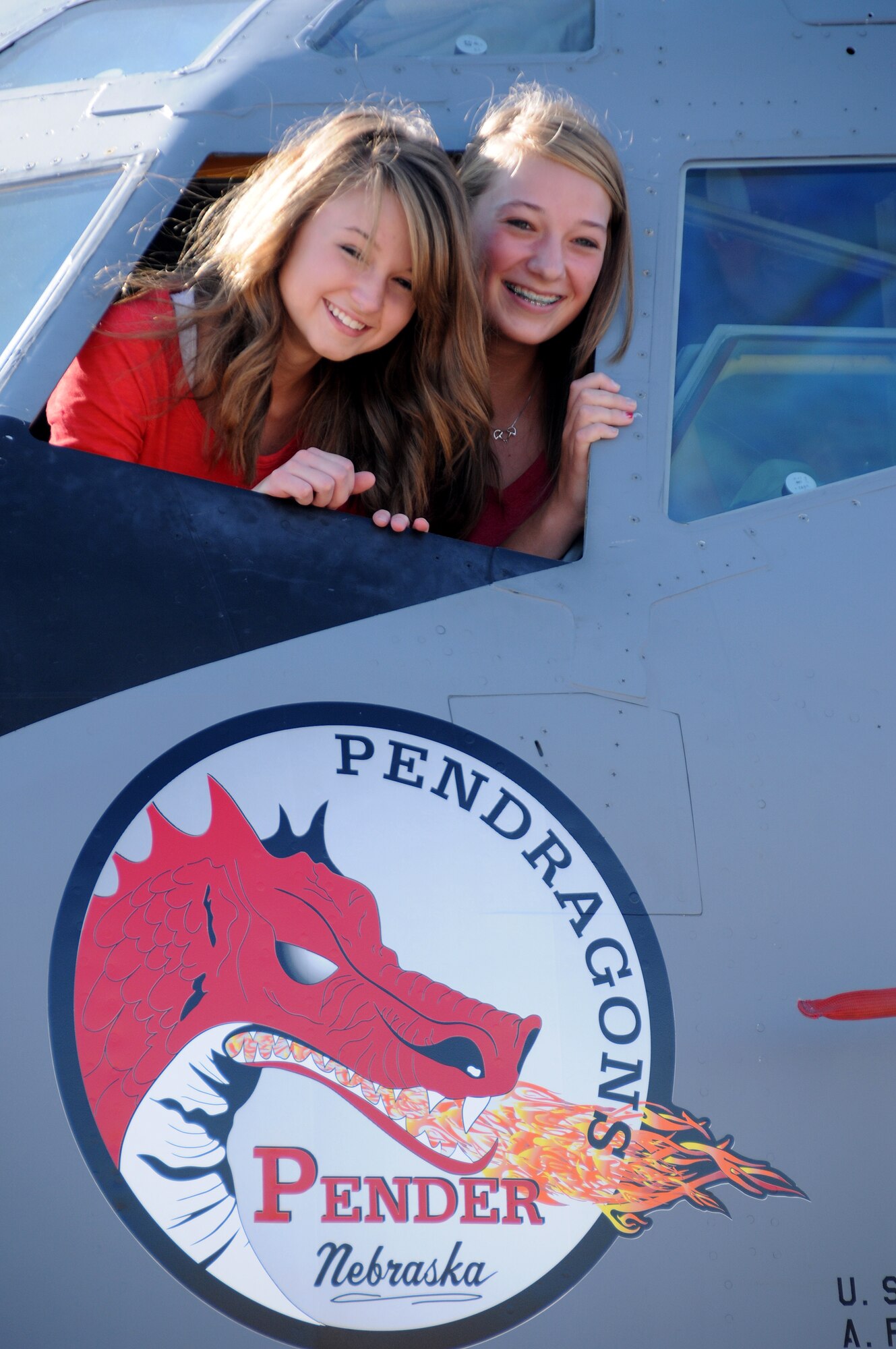 Brandy Buchholz (left) and Martina Juhlin, from Pender High School, look out from the Nebraska Air National Guard KC135R Stratotanker that carries their 2011 winning nose art design. The Nebraska Air Guard hosts an annual nose art program with schools around Nebraska to help promote the Air Guard and to make high school students aware of what the guard has to offer. 