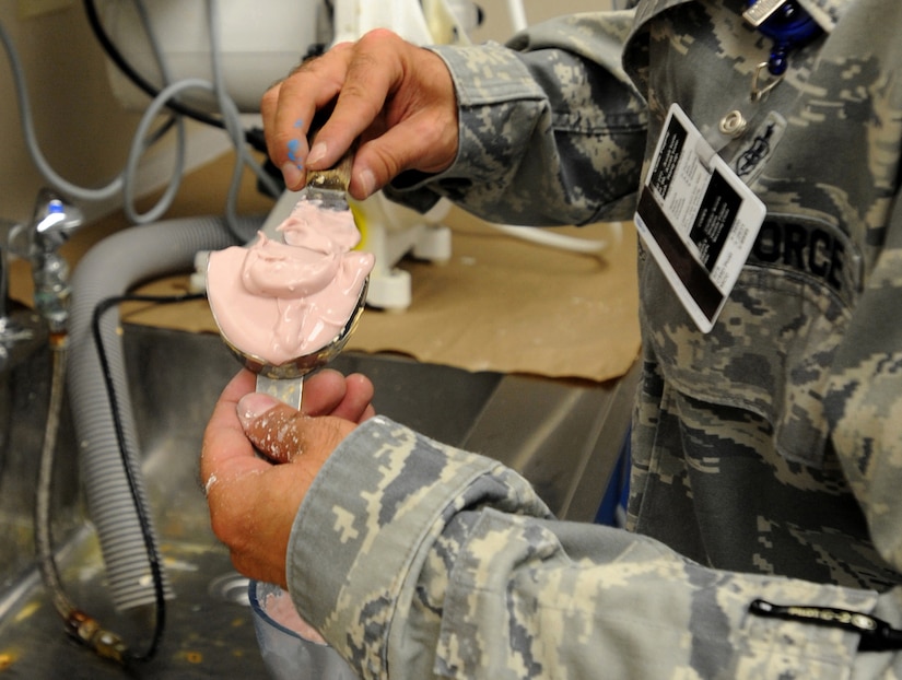 Technical Sergeant Joshuwa Steel puts molding into place in order to duplicate a model for a patients mouth guard at the Dental Lab Sept. 22 at Joint Base Charelston-Air Base. Dental Lab technicians fabricate all dental prosthesis, including making retainers, maxillary/mandible expanders, model work for pilots custom flight masks, sports guards, night guards, crowns, bridges and implants.  Steel is a Dental Lab technician with the 628th Medical Group. (U.S. Air Force photo/Airman 1st Class Ashlee Galloway)