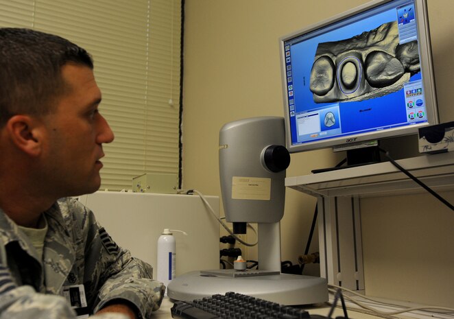 Technical Sergeant Joshuwa Steel designs a Computer Aided Design/Computer Aided Milling crown for a patient Sept. 22 at the Dental Lab at Joint Base Charleston-Air Base. Dental Lab technicians fabricate all dental prosthesis, including making retainers, maxillary/mandible expanders, model work for pilots custom flight masks, sports guards, night guards, crowns, bridges and implants.  Steel is a Dental Lab technician with the 628th Medical Group. (U.S. Air Force photo/Airman 1st Class Ashlee Galloway)