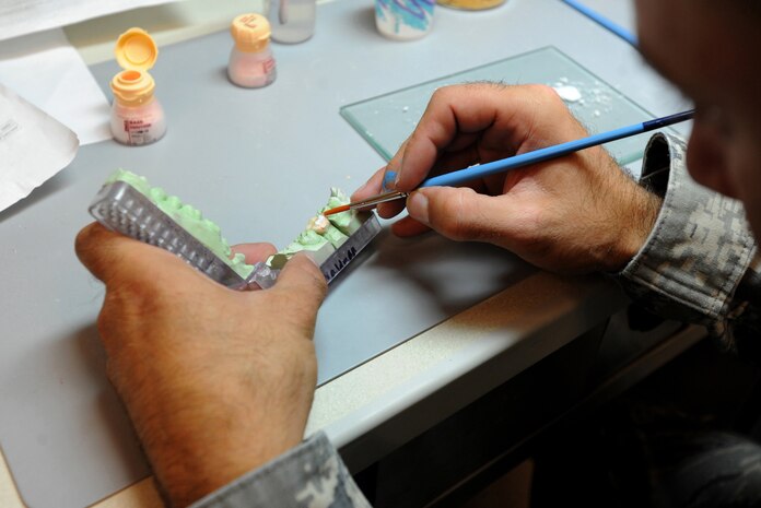 Technical Sergeant Joshuwa Steel adds enamel porcelain to a mold while making a crown for a patient Sept. 22, at the Dental Lab at Joint Bast Charleston-Air Base. Dental Lab technicians fabricate all dental prosthesis, including making retainers, maxillary/mandible expanders, model work for pilots custom flight masks, sports guards, night guards, crowns, bridges and implants.  Steel is a Dental technician with the 628th Medical Group. (U.S. Air Force photo/Airman 1st Class Ashlee Galloway)