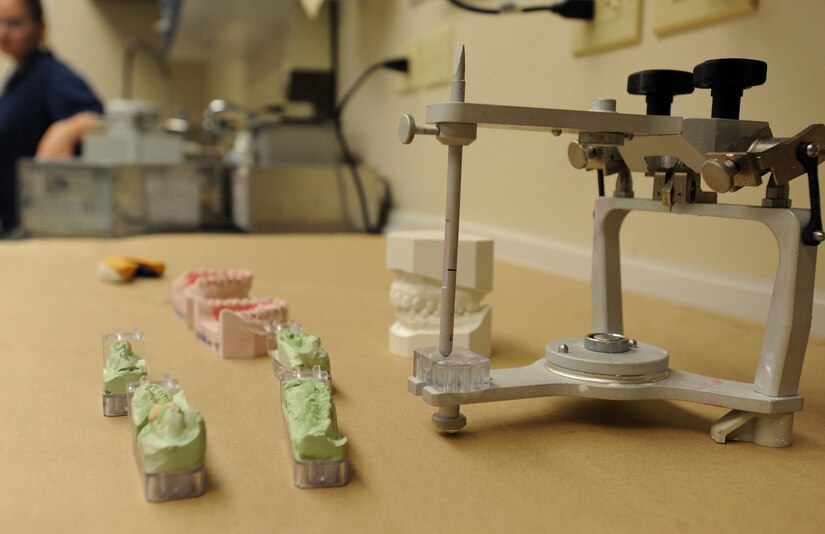 The Articulator is a machine that acts as a human jaw. At the Dental Lab on Joint Base Charleston, technicians use the Articulator to hold molds of the patients' mouths in the correct position so they can give the finished product to the dentist. If the mold positioning is even a millimeter off, it will not fit into the patients mouth properly and the process will have to start over. (U.S. Air Force photo/Airman 1st Class Ashlee Galloway)