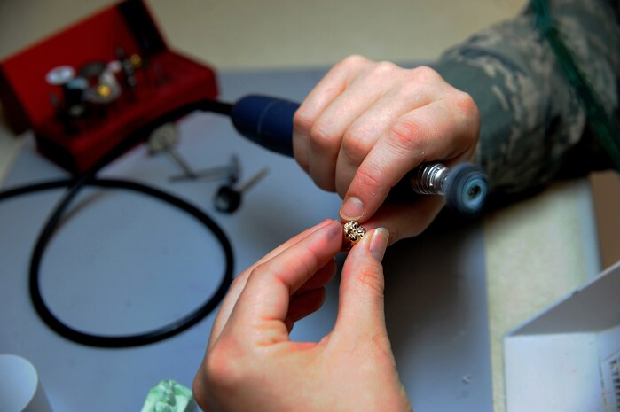 Senior Airman Meghan Mayhew polishes a gold crown at the Dental Lab Sept. 22 at Joint Base Charleston-Air Base. Dental Lab technicians fabricate all dental prothesis, inculding making retainers, maxillary/mandible expanders, model work for pilots custom flight masks, sports guards, night guards, crowns, bridges and implants. Mayhew is a Dental Lab technician with the 628th Medical Group. (U.S. Air Force photo/Airman 1st Class Ashlee Galloway)