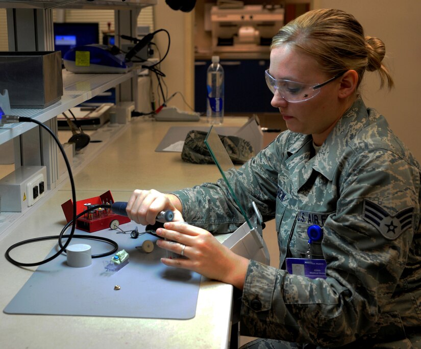 Senior Airman Meghan Mayhew polishes a gold crown at the Dental Lab Sept. 22 at Joint Base Charleston-Air Base. Dental Lab technicians fabricate all dental prosthesis, including making retainers, maxillary/mandible expanders, model work for pilots custom flight masks, sports guards, night guards, crowns, bridges and implants. Mayhew is a Dental Lab technician with the 628th Medical Group. (U.S. Air Force photo/Airman 1st Class Ashlee Galloway)