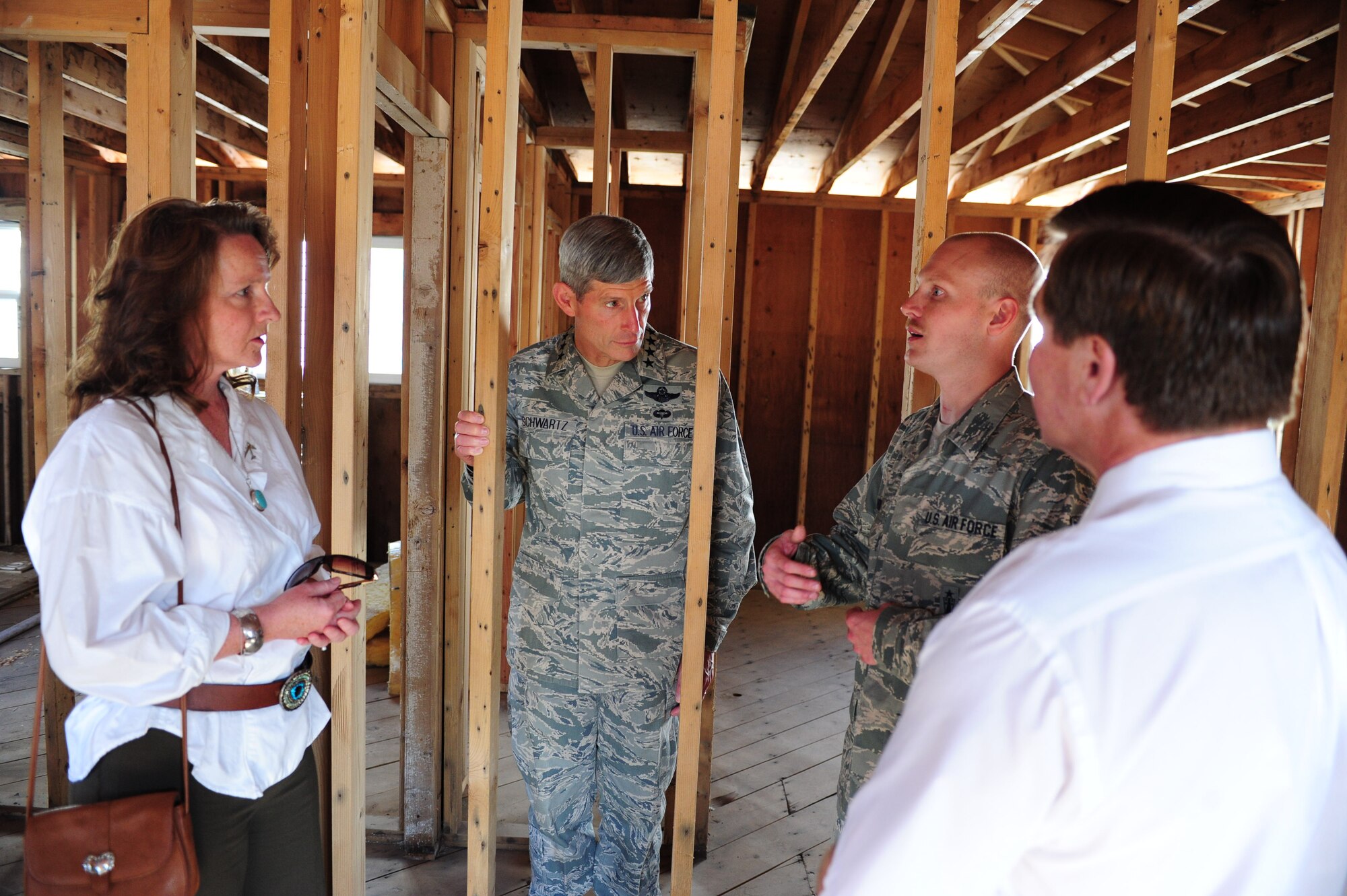Tech. Sgt. Robert Horn briefs Air Force Chief of Staff Gen. Norton Schwartz and local civic leaders Oct. 4, 2011, in Minot N.D., during a visit to Horn's flood-ravaged home. Schwartz visited the Horn family to see the flood areas in Minot and how the Airmen are recovering. Horn is an ICBM weapon system controller assigned to the 91st Operation Support Squadron. (U.S. Air Force photo/Senior Airman Michael Veloz)