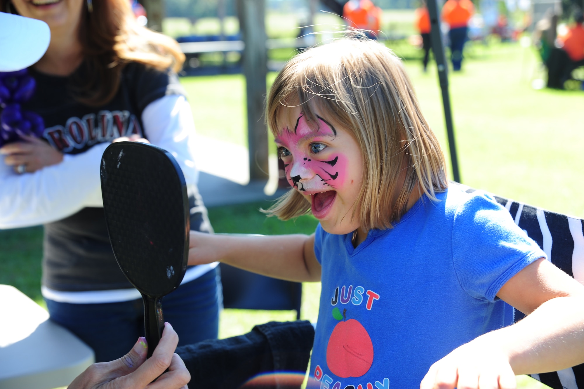 Kayla Helferich smiles at her kitty cat face  at the Child Find/Exceptional Family Member Program Extravaganza ‘Special Needs Fair’ Oct. 1, at Marrington Plantation, Joint Base Charleston-Weapons Station.The fair is designed to help families with children who have special needs by providing entertainment while  keeping them aware of the resources available on and off base. The extravaganza  featured fun, food, games, prizes and music provided by more than 20 local resources agencies. Kayla is the daughter of Michelle and Master Sgt. Joe Helferich assigned to the 628th Communications Squadron. (U.S. Air Force photo/Tech. Sgt Chrissy Best) 
