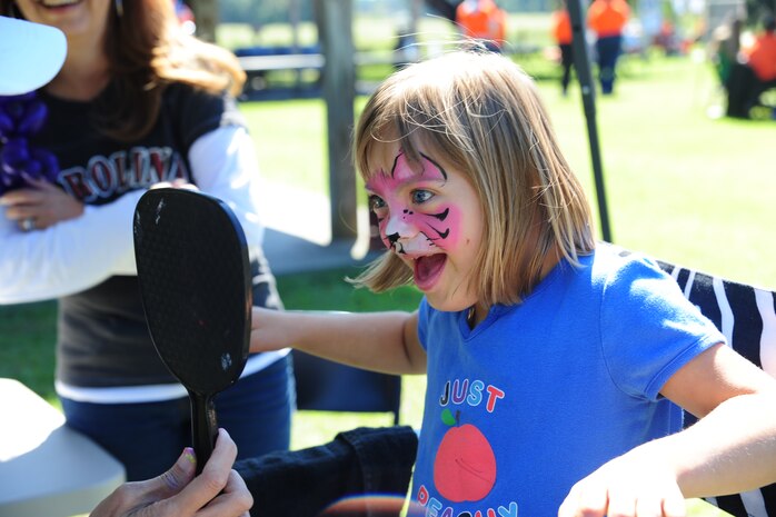 Kayla Helferich smiles at her kitty cat face  at the Child Find/Exceptional Family Member Program Extravaganza ‘Special Needs Fair’ Oct. 1, at Marrington Plantation, Joint Base Charleston-Weapons Station.The fair is designed to help families with children who have special needs by providing entertainment while  keeping them aware of the resources available on and off base. The extravaganza  featured fun, food, games, prizes and music provided by more than 20 local resources agencies. Kayla is the daughter of Michelle and Master Sgt. Joe Helferich assigned to the 628th Communications Squadron. (U.S. Air Force photo/Tech. Sgt Chrissy Best) 
