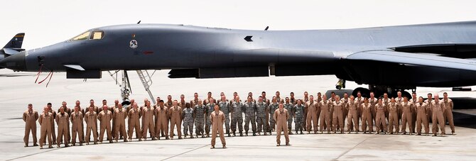 The 34th Expeditionary Bomb Squadron poses for a photograph with a B-1B Lancer at an undisclosed location in Southwest Asia.