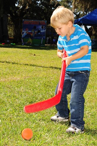 Lucas Helferich takes a shot and the Slap Shot game at the Child Find/Exceptional Family Member Program Extravaganza ?Special Needs Fair? Oct. 1 at Marrington Plantation, Joint Base Charleston-Weapons Station.The fair is designed to help families with children who have special needs by providing entertainment while  keeping them aware of the resources available on and off base. The extravaganza  featured fun, food, games, prizes and music provided by more than 20 local resources agencies. Lucas is son of Michelle and Master Sgt. Joe Helferich assigned to the 628th Communications Squadron. (U.S. Air Force photo/Tech. Sgt Chrissy Best) 