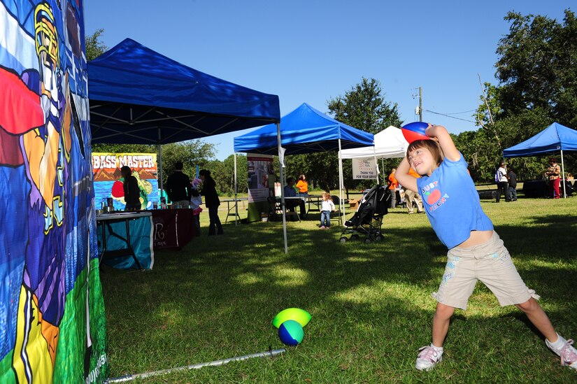 Kayla Helferich throws a football into the Quarterback toss game at the Child Find/Exceptional Family Member Program Extravaganza ?Special Needs Fair? Oct. 1, at Marrington Plantation, Joint Base Charleston-Weapons Station. The fair is designed to help families with children who have special needs by providing entertainment while  keeping them aware of the resources available on and off base. The extravaganza  featured fun, food, games, prizes and music provided by more than 20 local resources agencies.  Kayla is the daughter of Michelle and Master Sgt. Joe Helferich assigned to the 628th Communications Squadron. (U.S. Air Force photo/Tech. Sgt Chrissy Best) 