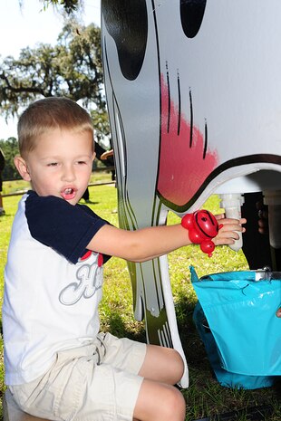 Winston Frechette milk a wooden cow at the Child Find/Exceptional Family Member Program Extravaganza ?Special Needs Fair? Oct. 1 2011, at Marrington Plantation, Joint Base Charleston-Weapons Station, hosted by JB-CHS.  The fair is designed to help families with children who have special needs by providing entertainment while  keeping them aware of the resources available on and off base. The extravaganza  featured fun, food, games, prizes and music provided by more than 20 local resources agencies. Winston is the son of Susan and 1st Lt. William Frechette, assigned to 628th Medical Group.( U.S. Air Force photo/Tech. Sgt Chrissy Best) 
