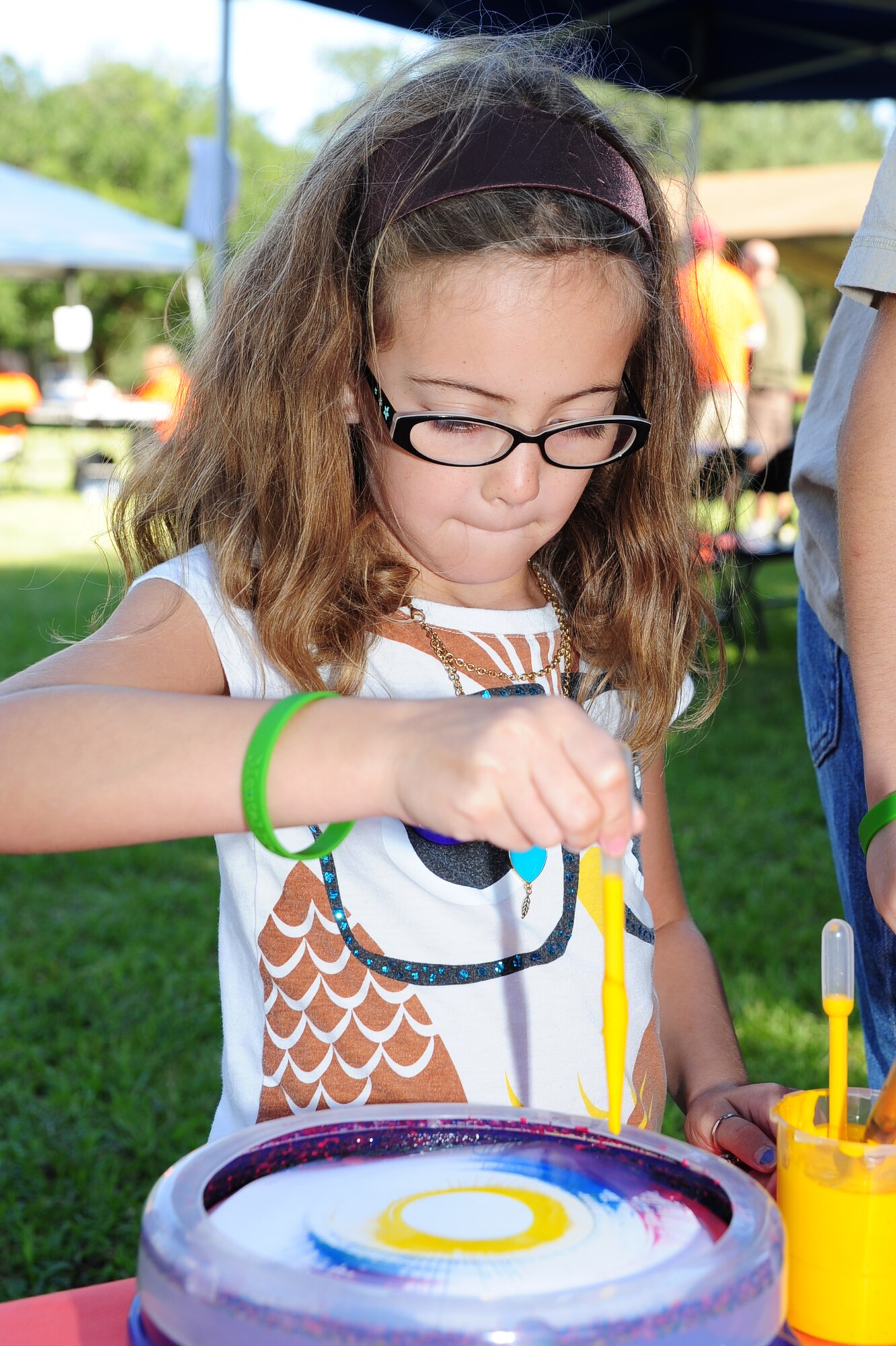 Ruby Castillo paints with the Spin Painter at the Child Find/Exceptional Family Member Program Extravaganza ?Special Needs Fair? Oct. 1, at Marrington Plantation, Joint Base Charleston-Weapons Station. The fair is designed to help families with children who have special needs by providing entertainment while  keeping them aware of the resources available on and off base. The extravaganza  featured fun, food, games, prizes and music provided by more than 20 local resources agencies. Ruby is the daughter of Nicole and Staff Sgt. Michael Castillo, assigned to the 437th Maintenance Operations Squadron. (U.S. Air Force photo/Tech. Sgt Chrissy Best) 
