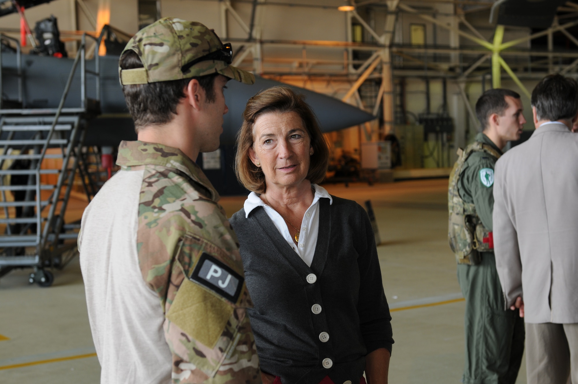 ROYAL AIR FORCE LAKENHEATH, England - Senior Airman Eli Reynolds, 56th Rescue Squadron pararescueman, talks with High Sheriff of Norfolk Georgina Holloway during a base visit, Oct. 3, 2011.  The High Sheriffs of Norfolk, Suffolk, and Cambridgeshire and their spouses took a tour of the propulsion shop, air traffic control tower, Hangar 7 and the child development center to continue to build partnership capacities with local community leaders.  (U.S. Air Force photo by Airman Cory D. Payne)