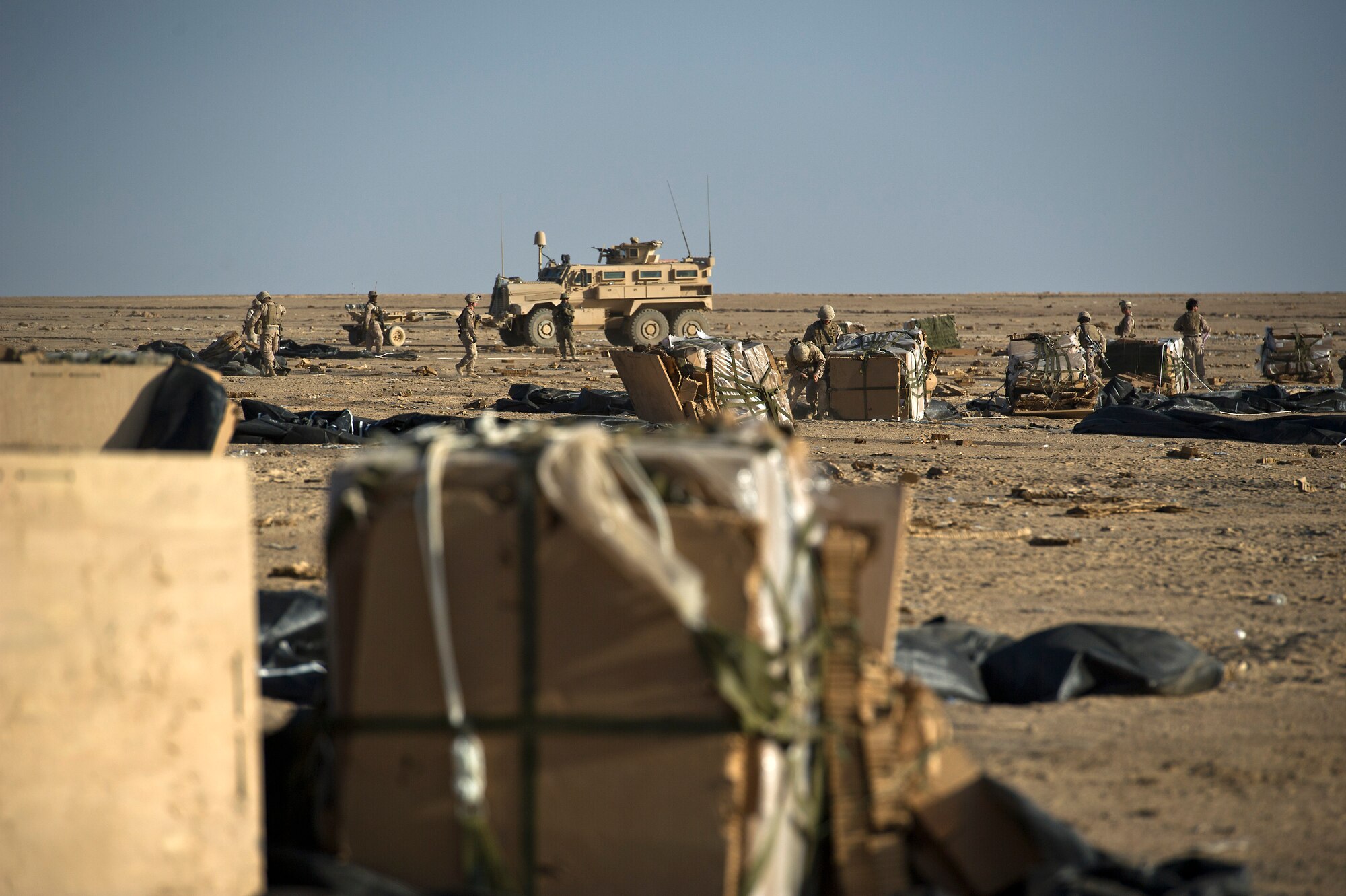 U.S. Marines clear parachutes and other packing material away from bundles of food rations that were airdropped to Forward Operating Base Edinburgh, the logistics hub for Northern Helmand Province, on Oct 3, 2011.  The parachutes and other packing material are collected and burned on site to reduce the debris left on the drop zone. Aerial delivery of food and water allows Marines to get some critical supplies without having to rely on risky ground convoys.   (U.S. Air Force Photo/Master Sgt. Jeffrey Allen)