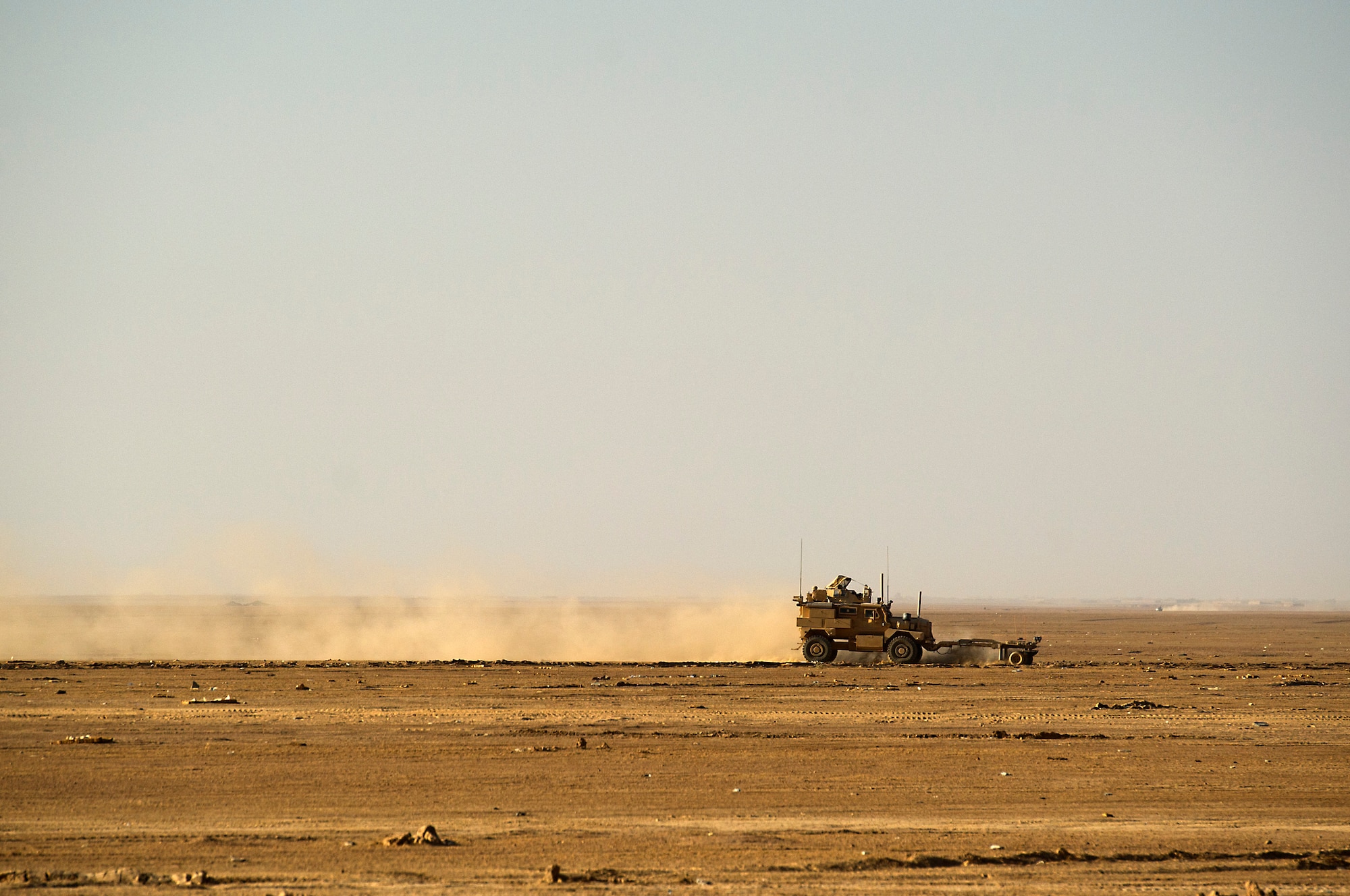 A U. S. Marine Mine Resistant Ambush Protected vehicle clears the road to the drop zone at Forward Operating Base Edinburgh, the logistics hub for Northern Helmand Province, on Oct 3, 2011.  The route to the drop zone is being cleared so a team of Marines can collect food rations  recently airdropped by a C-130 Hercules. Aerial delivery of food and water allows Marines to get some critical supplies without having to rely on risky ground convoys.   (U.S. Air Force Photo/Master Sgt. Jeffrey Allen)